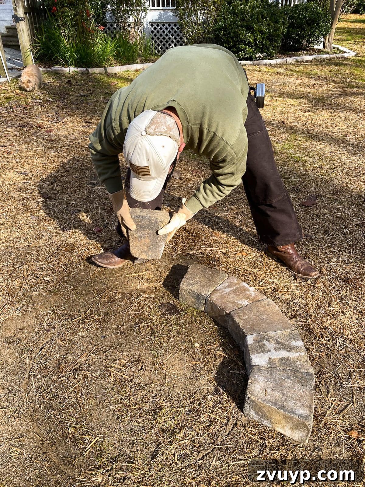 Weekend Wonder: DIY Pea Gravel Fire Pit 10 Dry fitting the stone fire pit kit to ensure proper sizing and placement within the patio area.