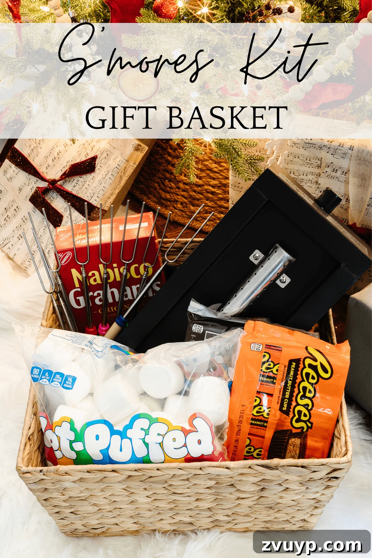 50 Festive Hamper Inspirations 7 S'mores Kit Gift Basket with a tabletop fire pit, roasting skewers, marshmallows, chocolate bars, Reese's cups, and a lighter.