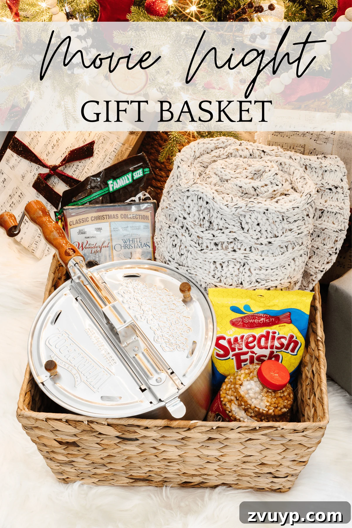 50 Festive Hamper Inspirations 4 Movie Night Gift Basket with popcorn maker, kernels, a Christmas movie, candy, and a throw blanket.