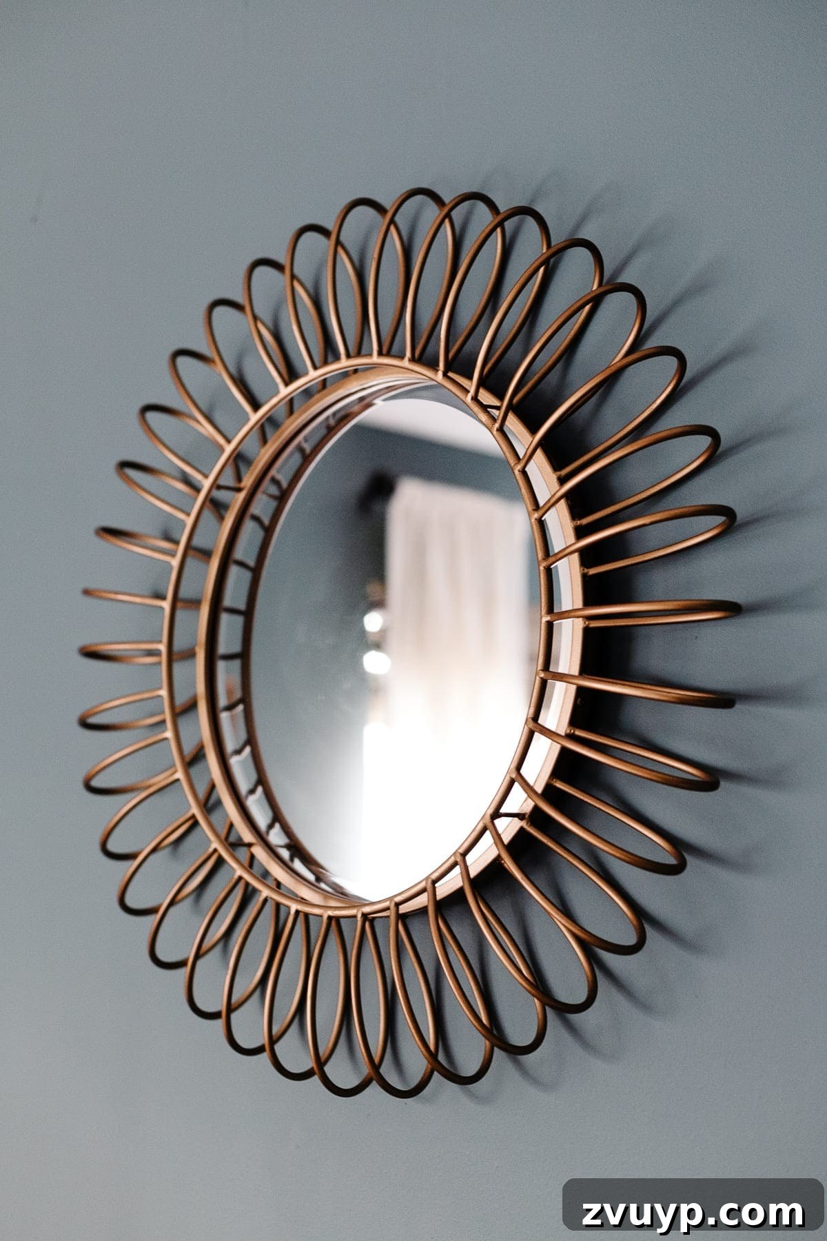 Crafting a Spa Sanctuary: Bedroom Decor for Ultimate Serenity 11 Gold round mirror above the bed in a teal and blush bedroom