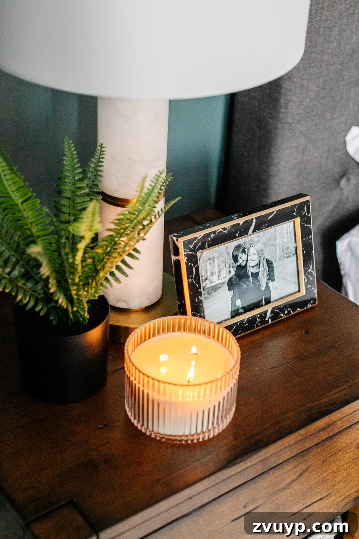 Crafting a Spa Sanctuary: Bedroom Decor for Ultimate Serenity 17 Close-up of a wooden nightstand with personal photos and decor