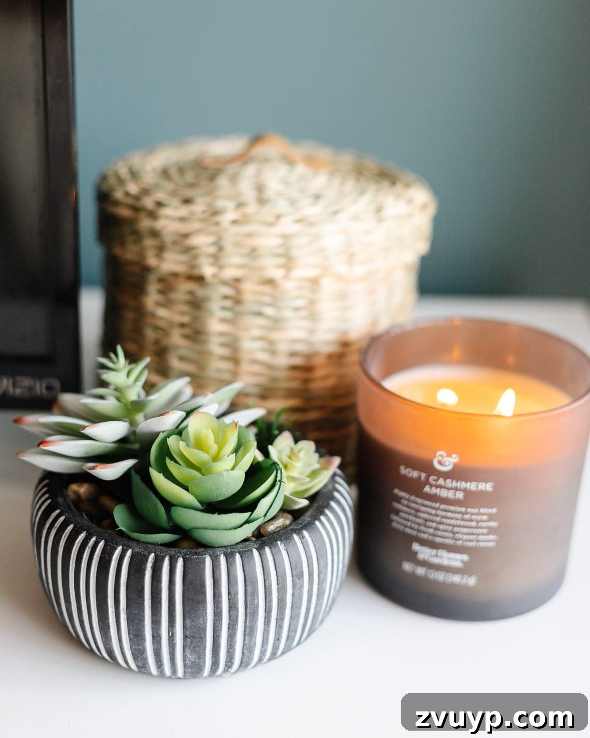 Crafting a Spa Sanctuary: Bedroom Decor for Ultimate Serenity 21 Potted faux succulents and a candle on a dresser in a teal bedroom