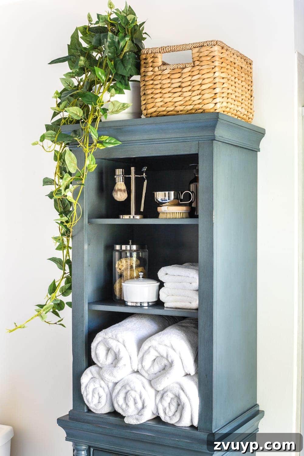Smart Organization Solutions for a Clutter Free Home 19 A bathroom linen closet with neatly stacked, rolled white towels, embodying a clean and organized aesthetic.