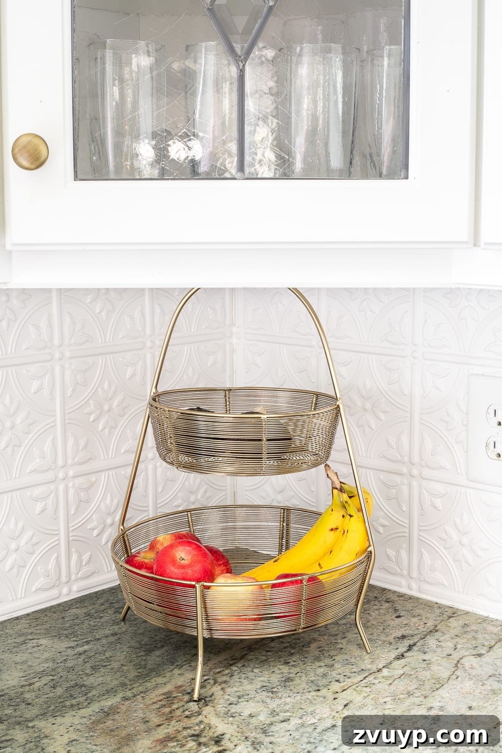 Smart Organization Solutions for a Clutter Free Home 21 A tiered basket holding a variety of fresh fruits on a kitchen countertop, keeping produce organized and accessible.