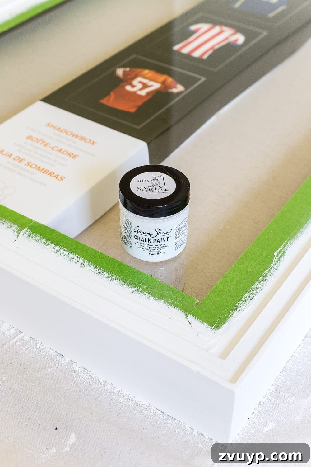 Prepping a shadow box frame, showing a backer board covered in canvas drop cloth.