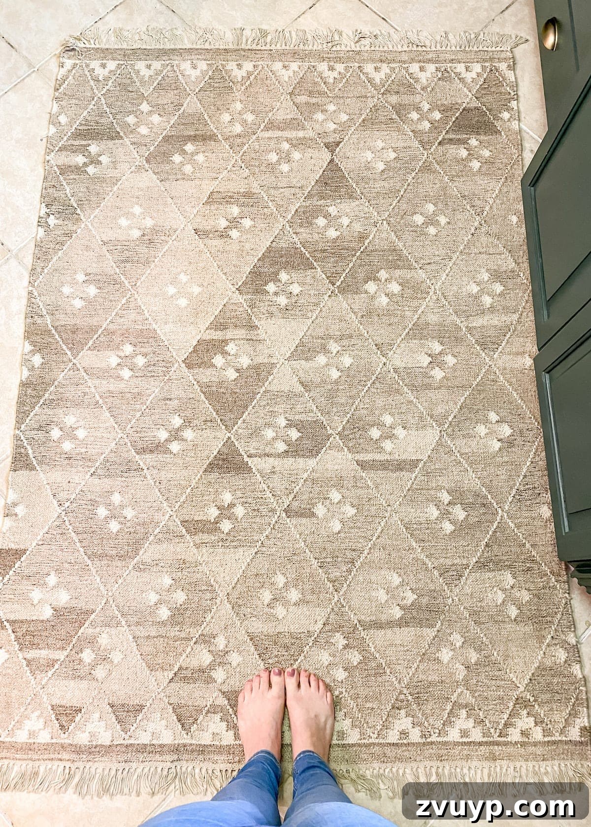 Measuring and marking a flatweave rug with a fabric pen for cutting.