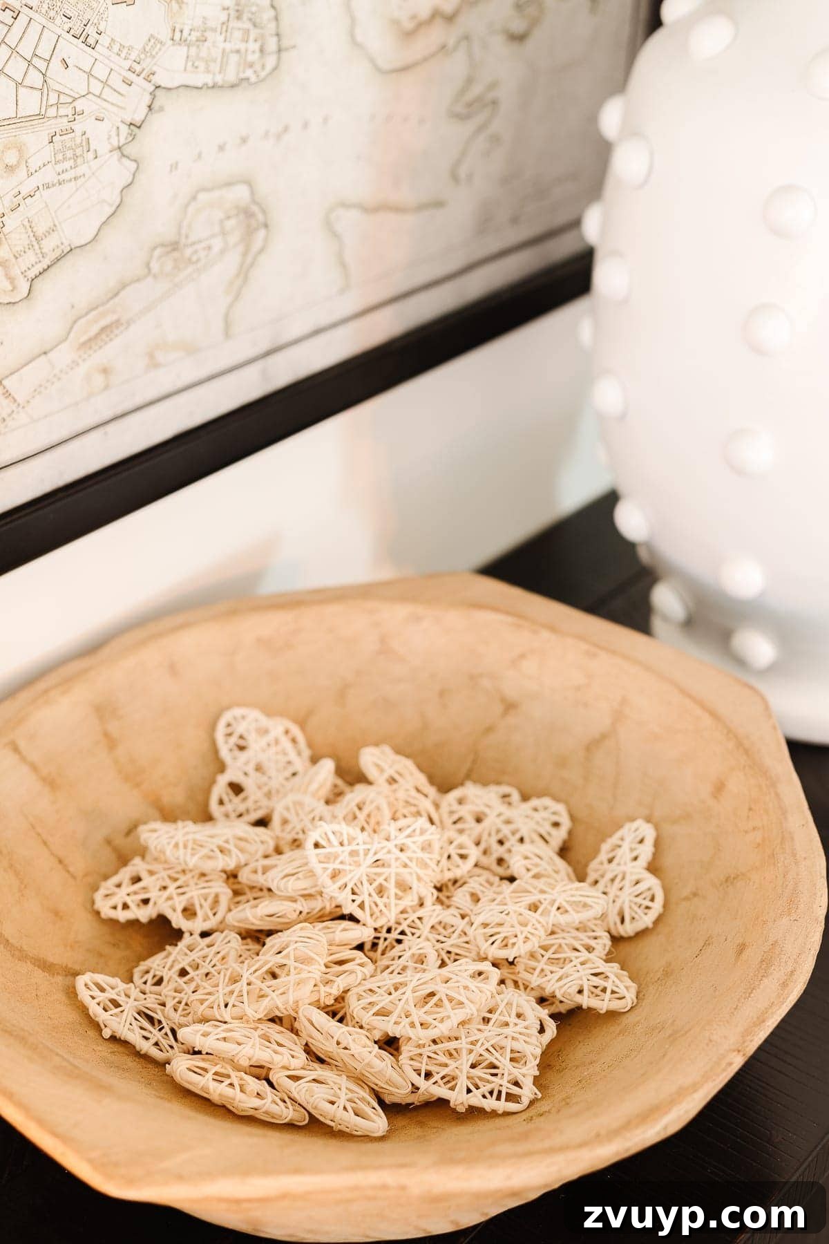 Chic Valentine's Ambiance 6 Wooden bowl filled with neutral rattan hearts for a subtle, year-round Valentine's touch.
