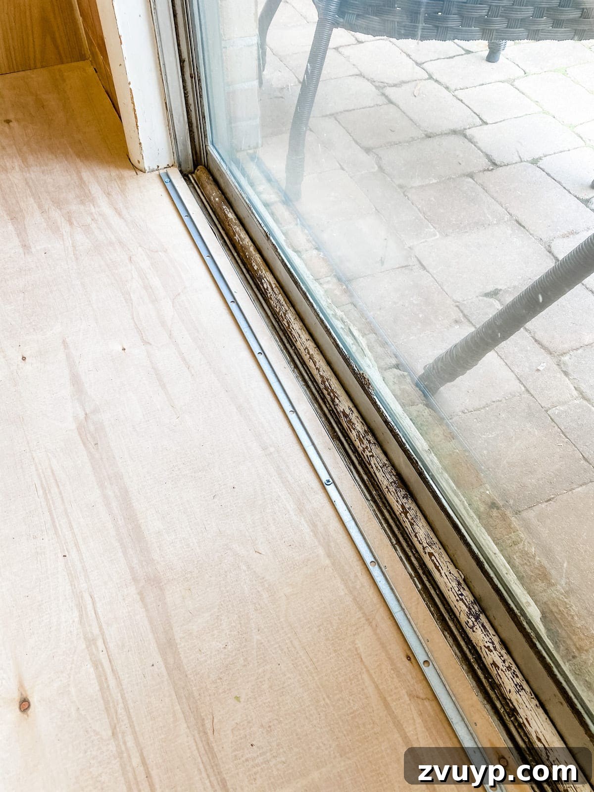 installing a threshold for luxury vinyl plank flooring by drilling a metal piece