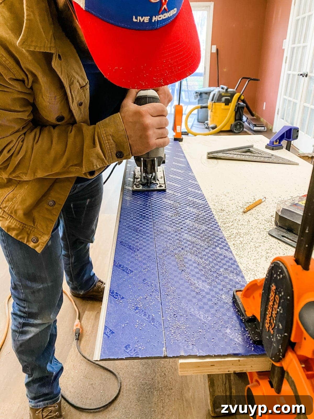 Using a jigsaw to cut luxury vinyl plank flooring for an irregular shape