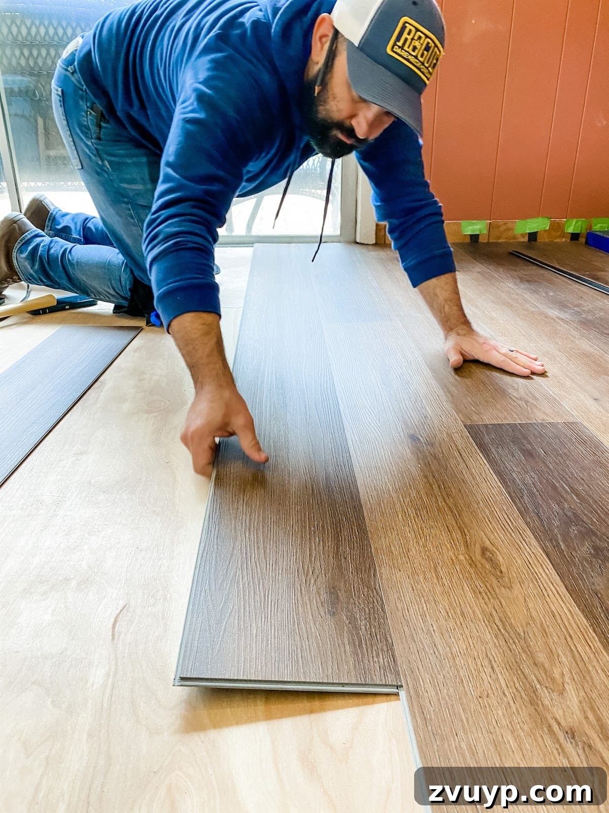 How to install luxury vinyl plank flooring, showing the plank locking into the previous row
