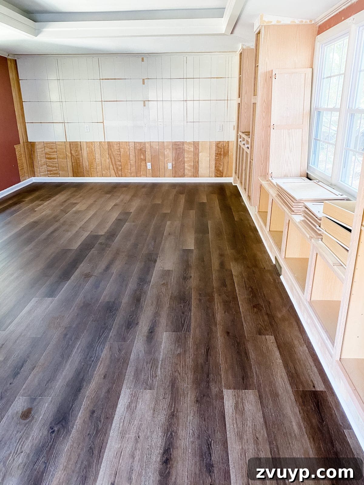 Luxury vinyl plank flooring installed with new baseboards