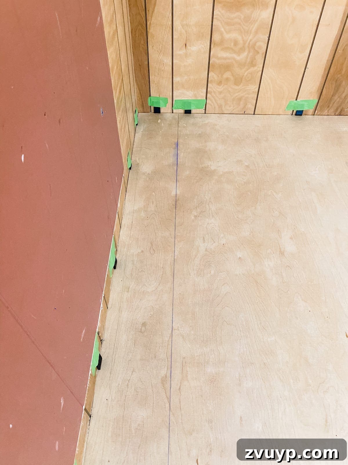 Setting a chalk line before installing the first row of luxury vinyl plank flooring to ensure a straight line as the starting point