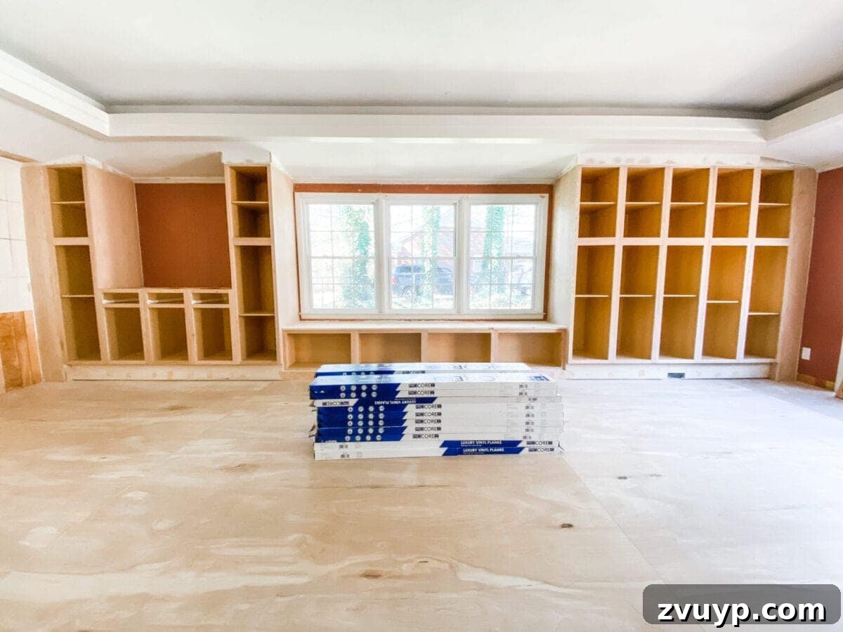 DIY Custom Built-In Storage and Window Nook 4 Rec room showing the installed cabinet frames for the built-ins and window seat, awaiting doors and finishing