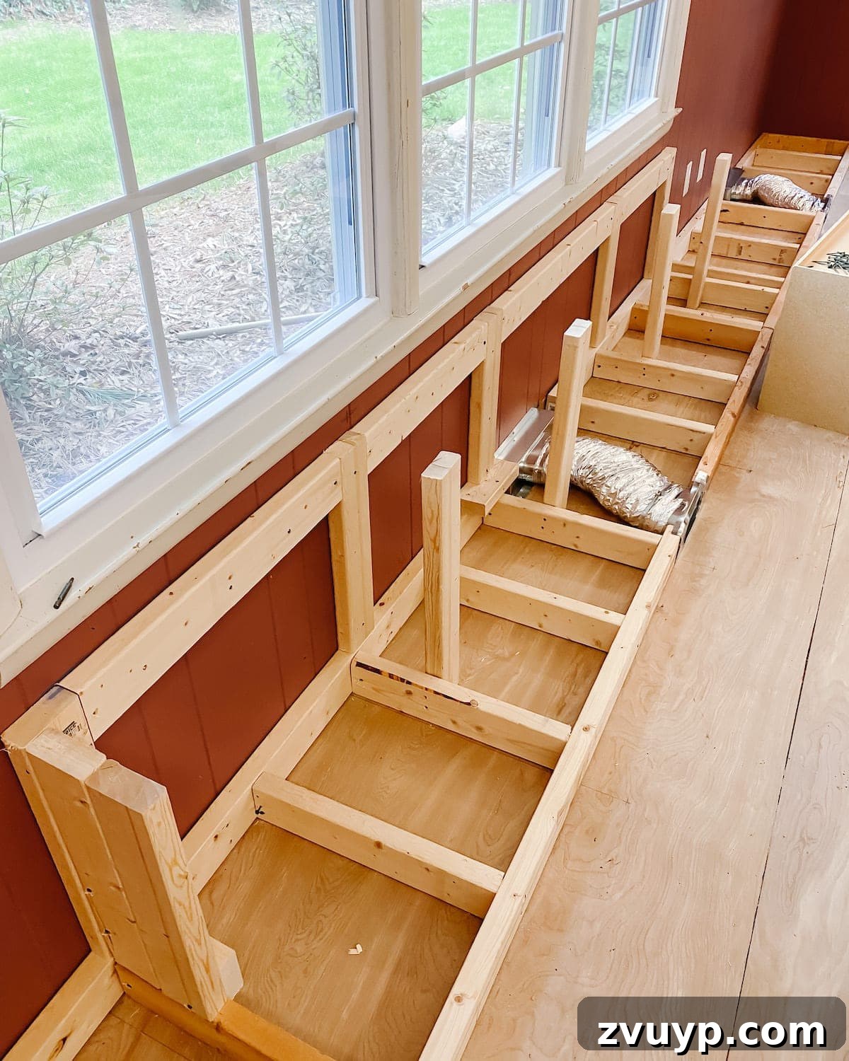 DIY Custom Built-In Storage and Window Nook 8 2x4 support frame built behind the refrigerator cabinets for the window seat depth