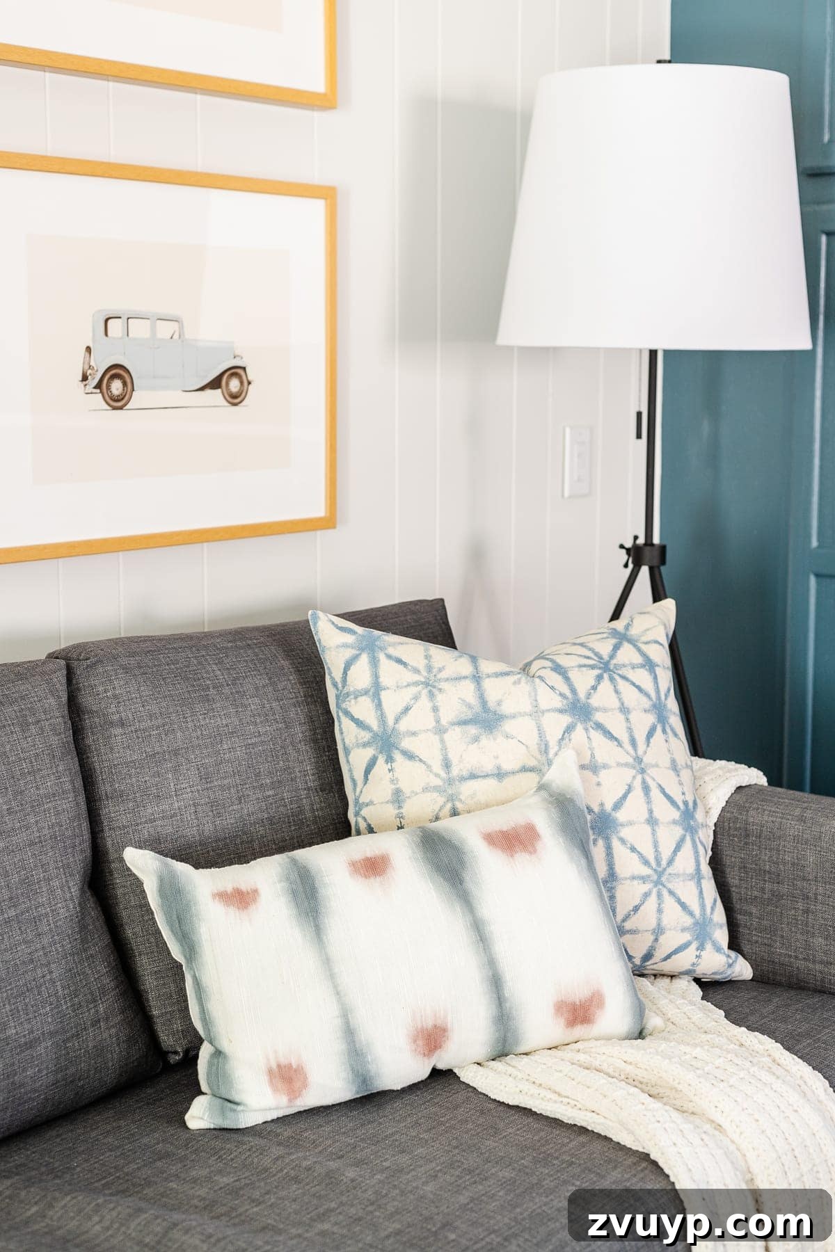 From Drab to Dream Den: Our Rec Room's Big Reveal 12 Sleeper sofa with patterned pillows and throws