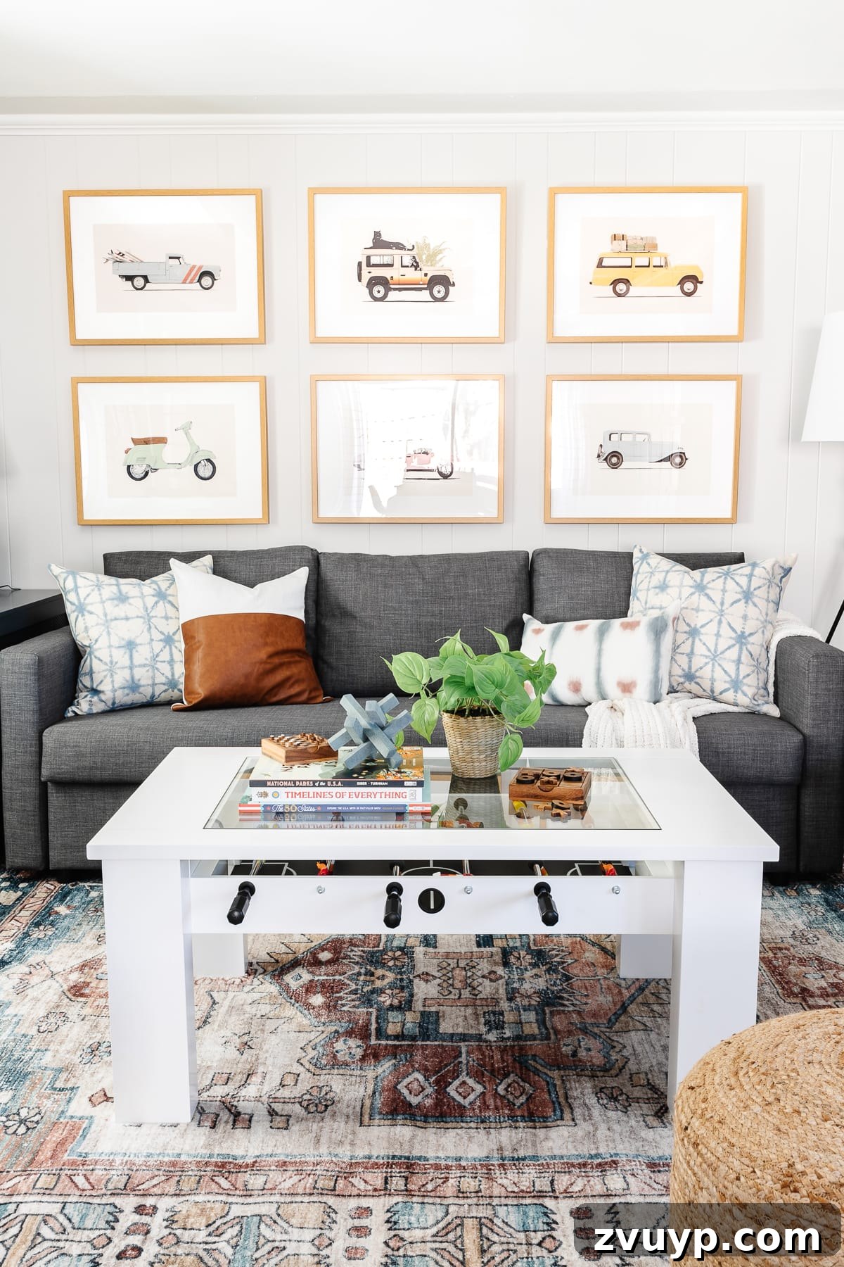 From Drab to Dream Den: Our Rec Room's Big Reveal 14 Vintage car art prints on a gallery wall with subtle animal motifs