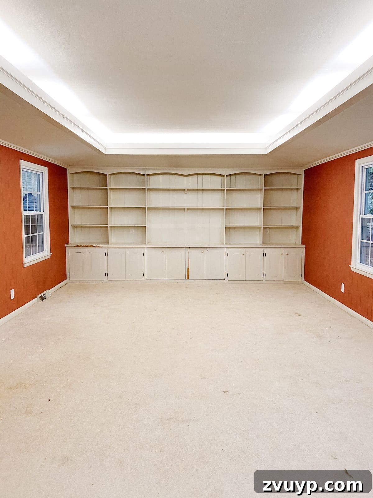 From Drab to Dream Den: Our Rec Room's Big Reveal 3 Before shot of the rec room with old built-ins and worn carpet