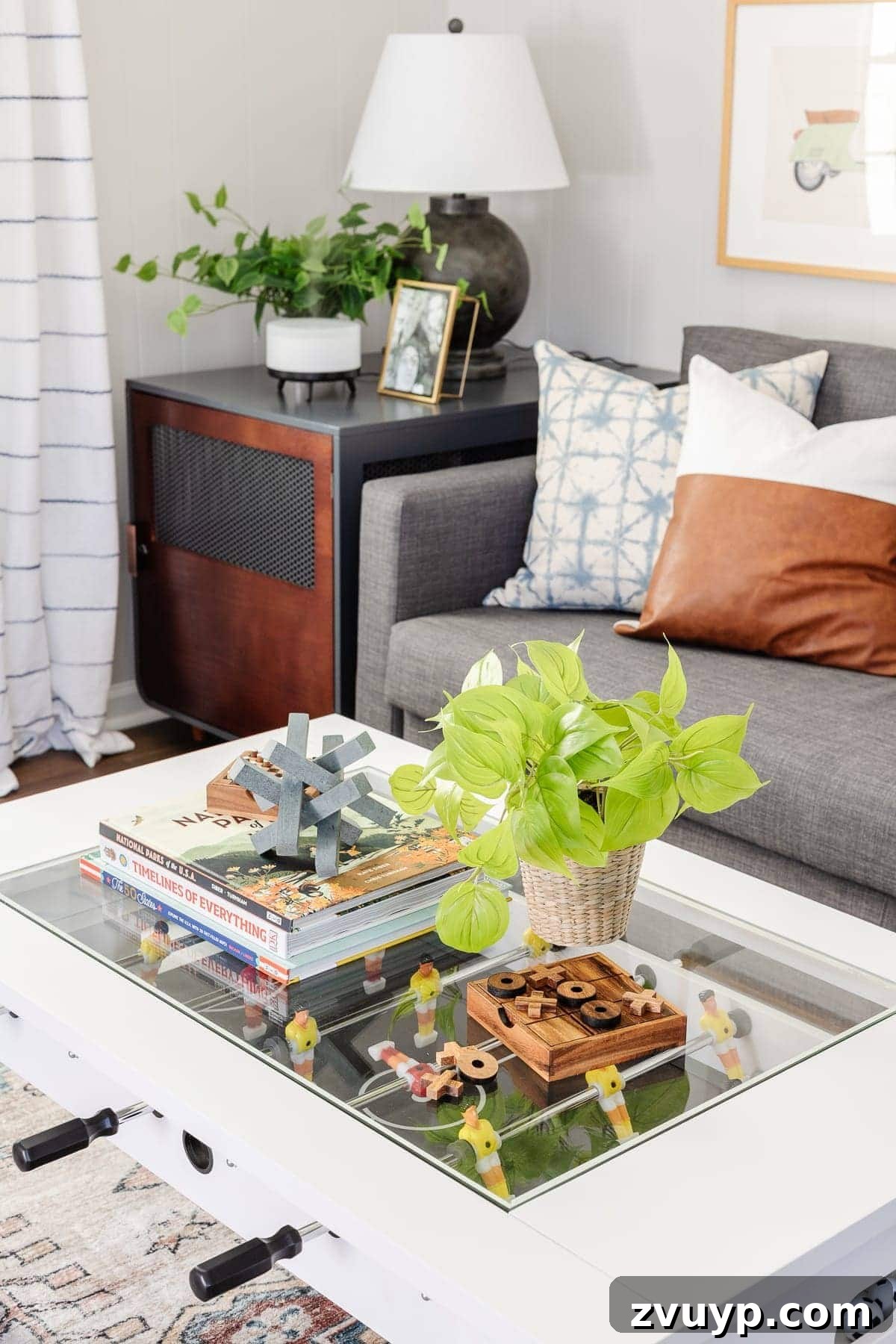 From Drab to Dream Den: Our Rec Room's Big Reveal 9 Foosball coffee table with decorative books and games