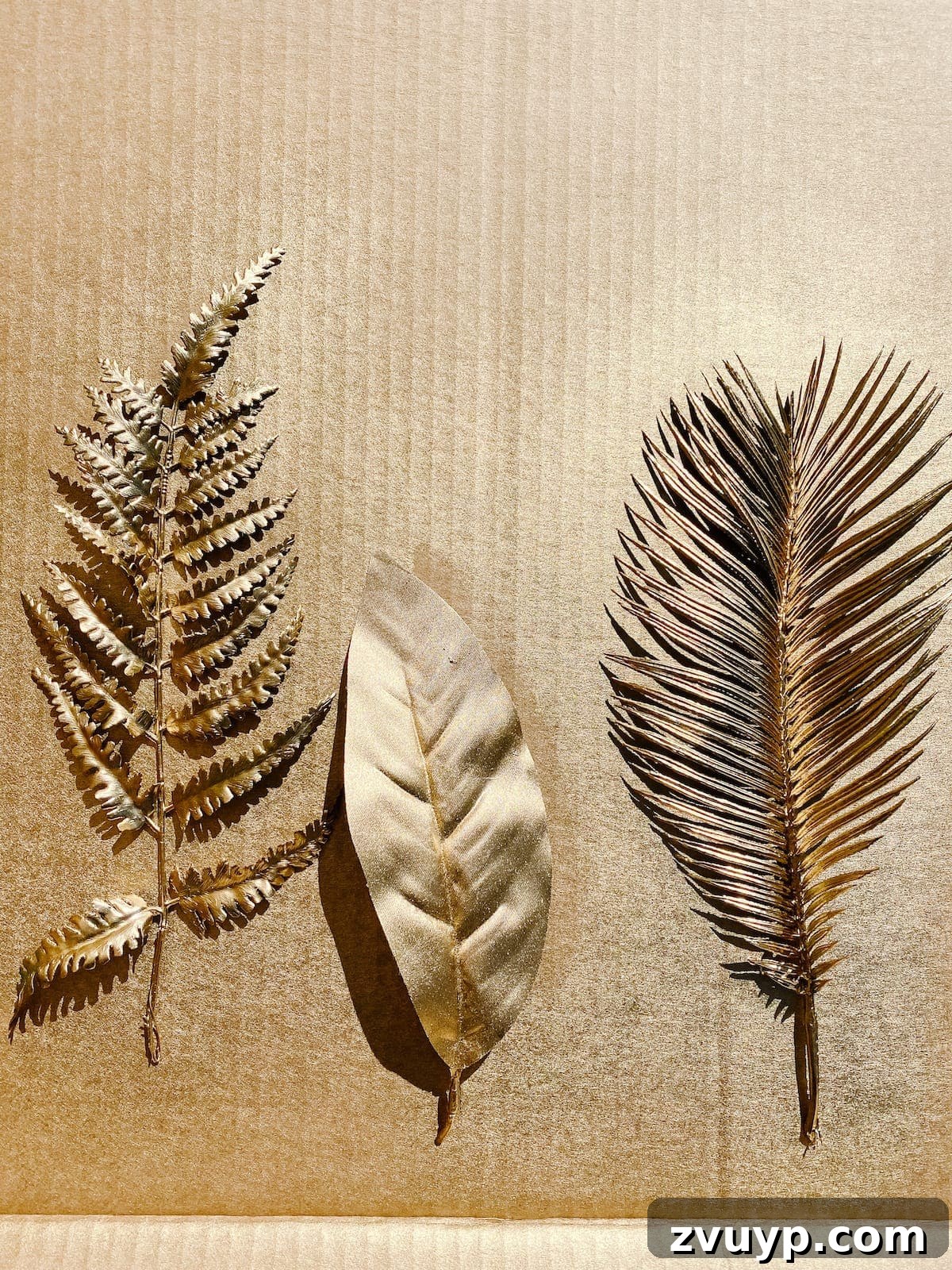 DIY Gold Leaf Sculpture: Luxury for Less 4 Faux leaves spray painted metallic gold and drying.