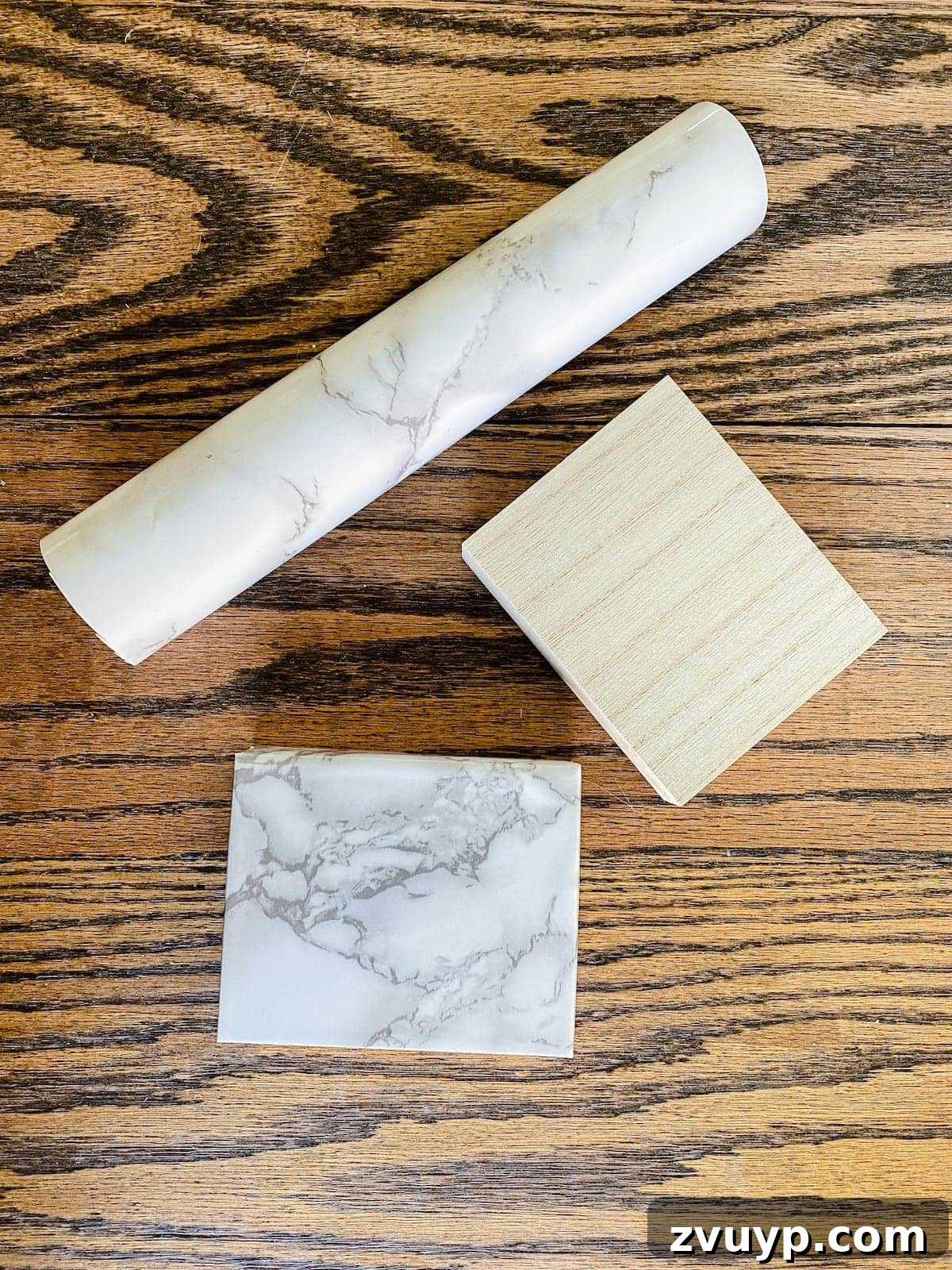 DIY Gold Leaf Sculpture: Luxury for Less 5 Scrap wood block expertly wrapped in marble contact paper, resembling a high-end base.