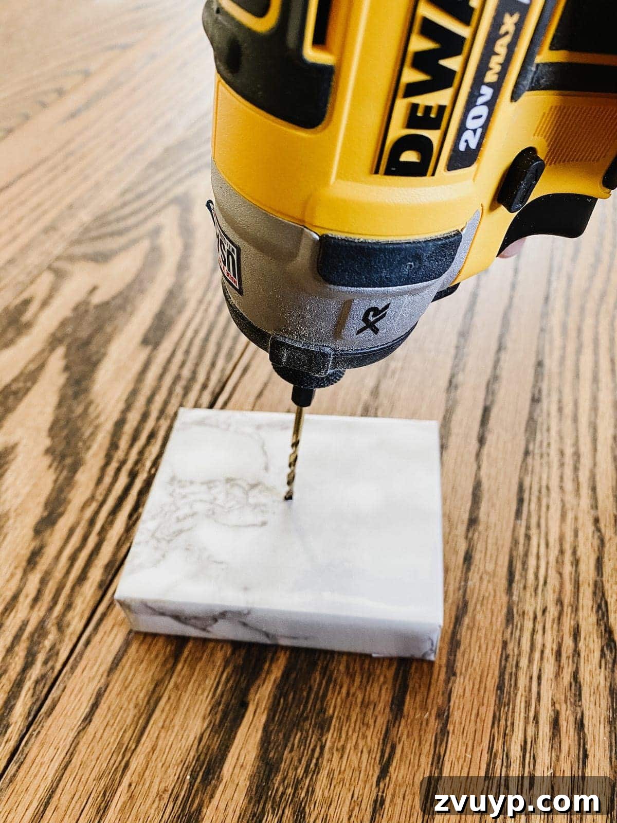DIY Gold Leaf Sculpture: Luxury for Less 6 Marble-wrapped scrap wood block with a drilled hole in the center, ready for leaf insertion.