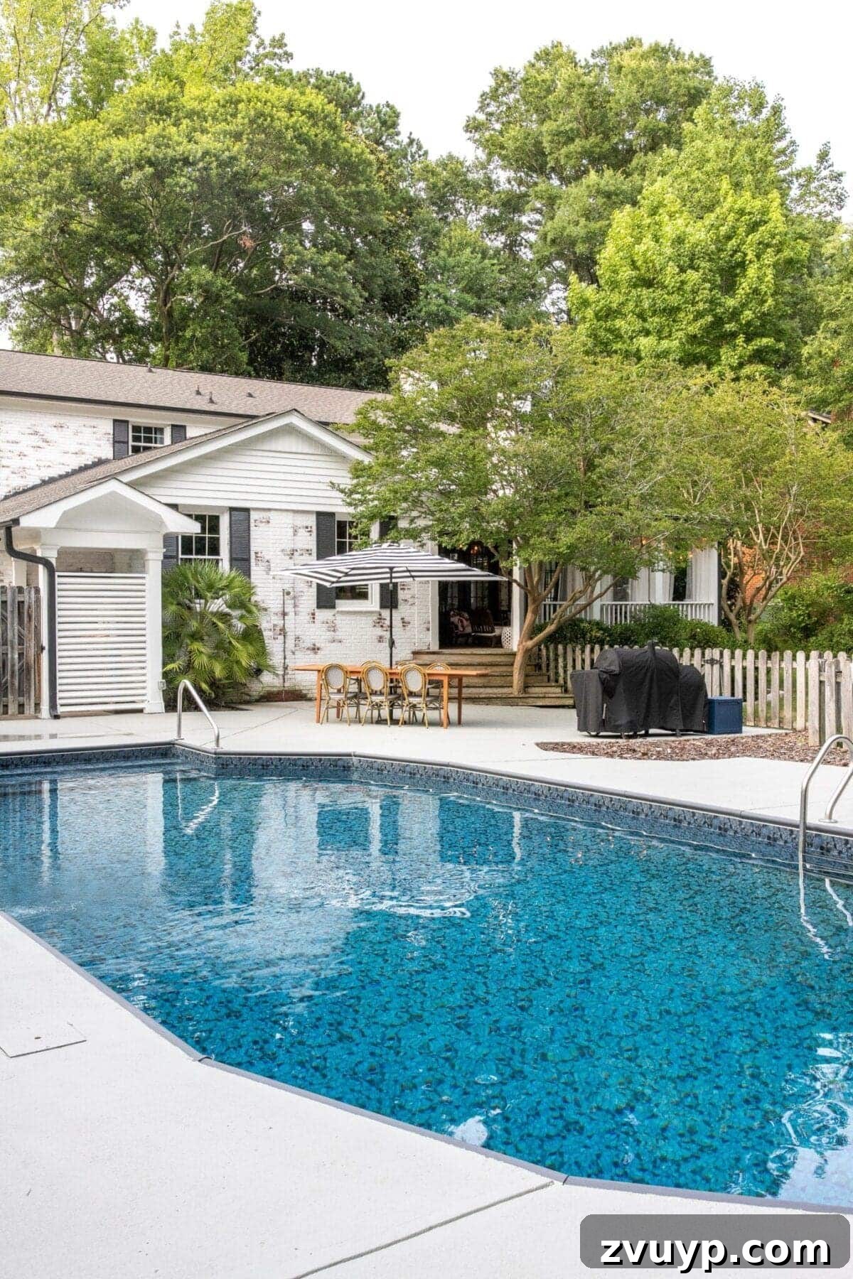 10 Spring DIY Projects for an Outdoor Oasis 2 Refreshing painted pool deck and sparkling pool ready for summer fun.