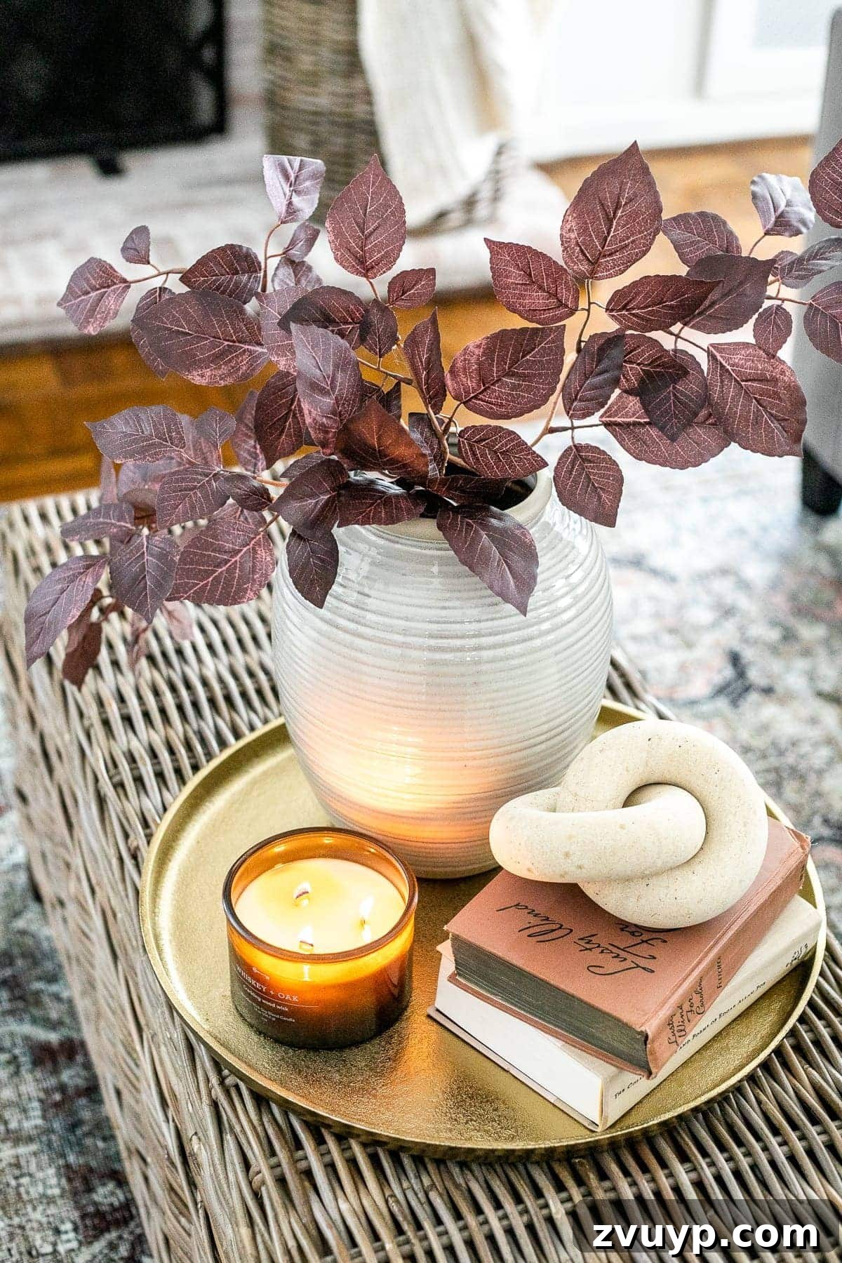 Simple Steps to a Stunning Coffee Table 16 Cozy fall living room coffee table idea with brass tray, autumn leaves, wooden knot, and scented candle