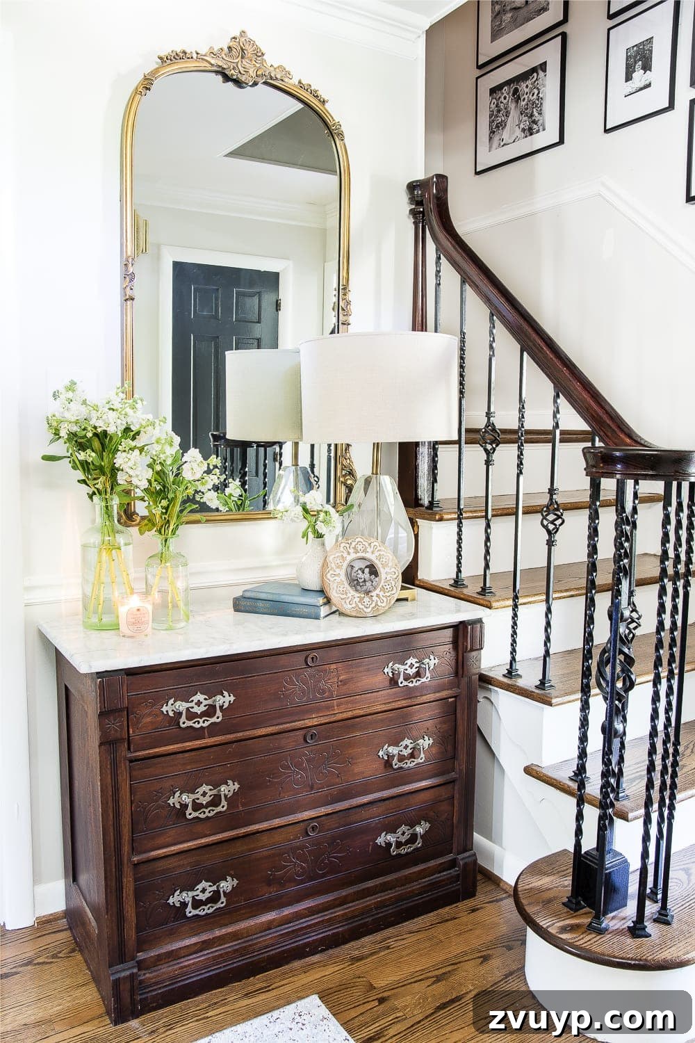 Timeless Gold Mirrors Elegance for Every Budget 3 Stunning antique gold mirror as a focal point in a classic entryway with elegant decor elements.