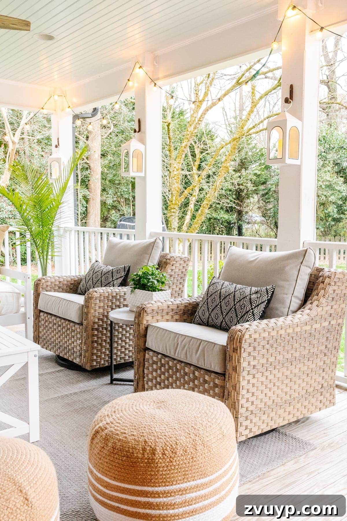 Revitalizing Our Outdoor Retreat 3 Two comfortable swivel chairs from the 5-piece conversation set on the refreshed back porch, ready for relaxation.
