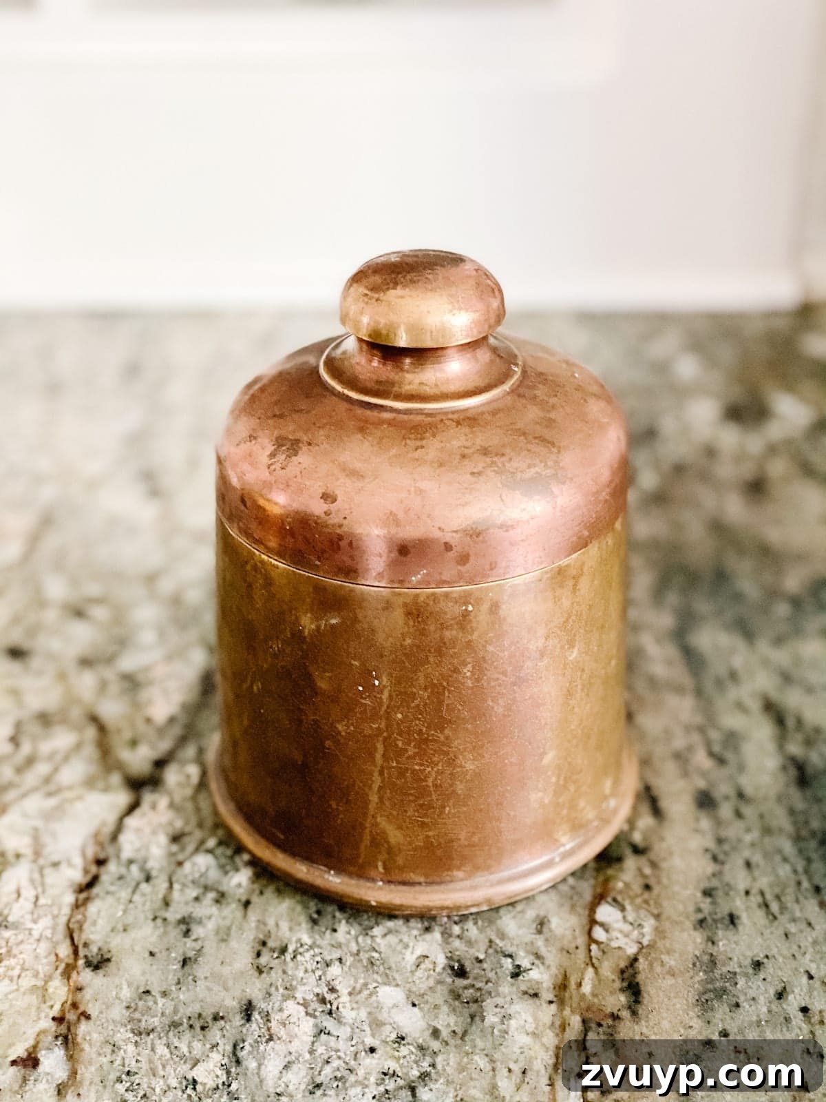 Transforming Thrifted Brass into Elegant Candles 2 A beautifully upcycled DIY candle in an antique brass canister, showcasing the elegance of repurposed items.