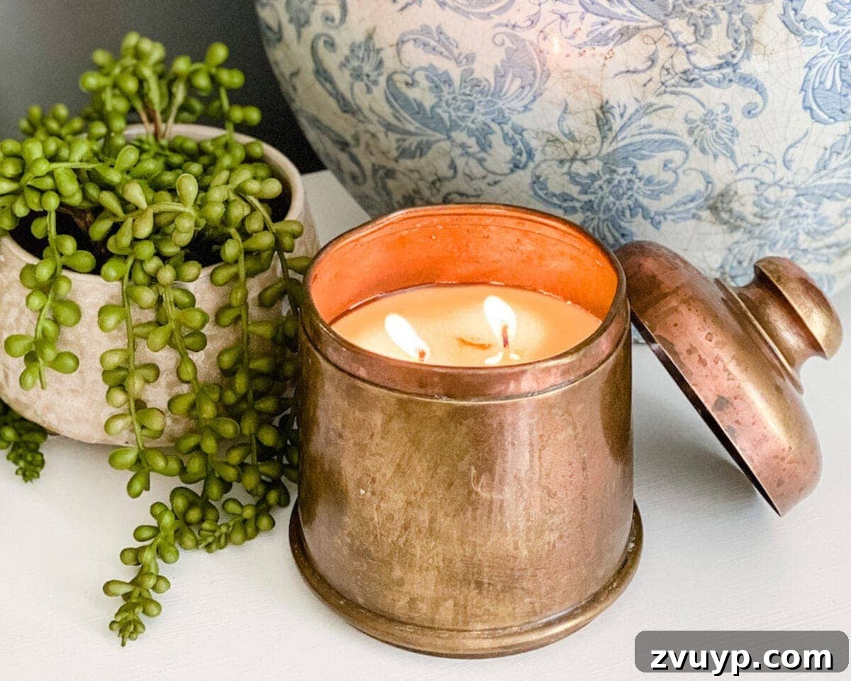 Transforming Thrifted Brass into Elegant Candles 9 Finished candle made from a thrifted antique brass canister, ready for display.
