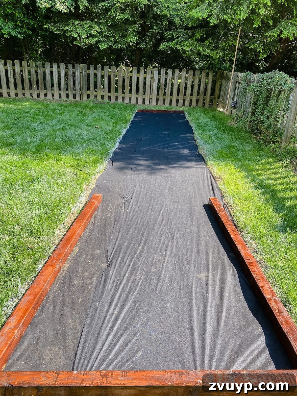Get Rolling Build a Bocce Court in a Weekend 13 Laying down weed barrier fabric for the bocce ball court base
