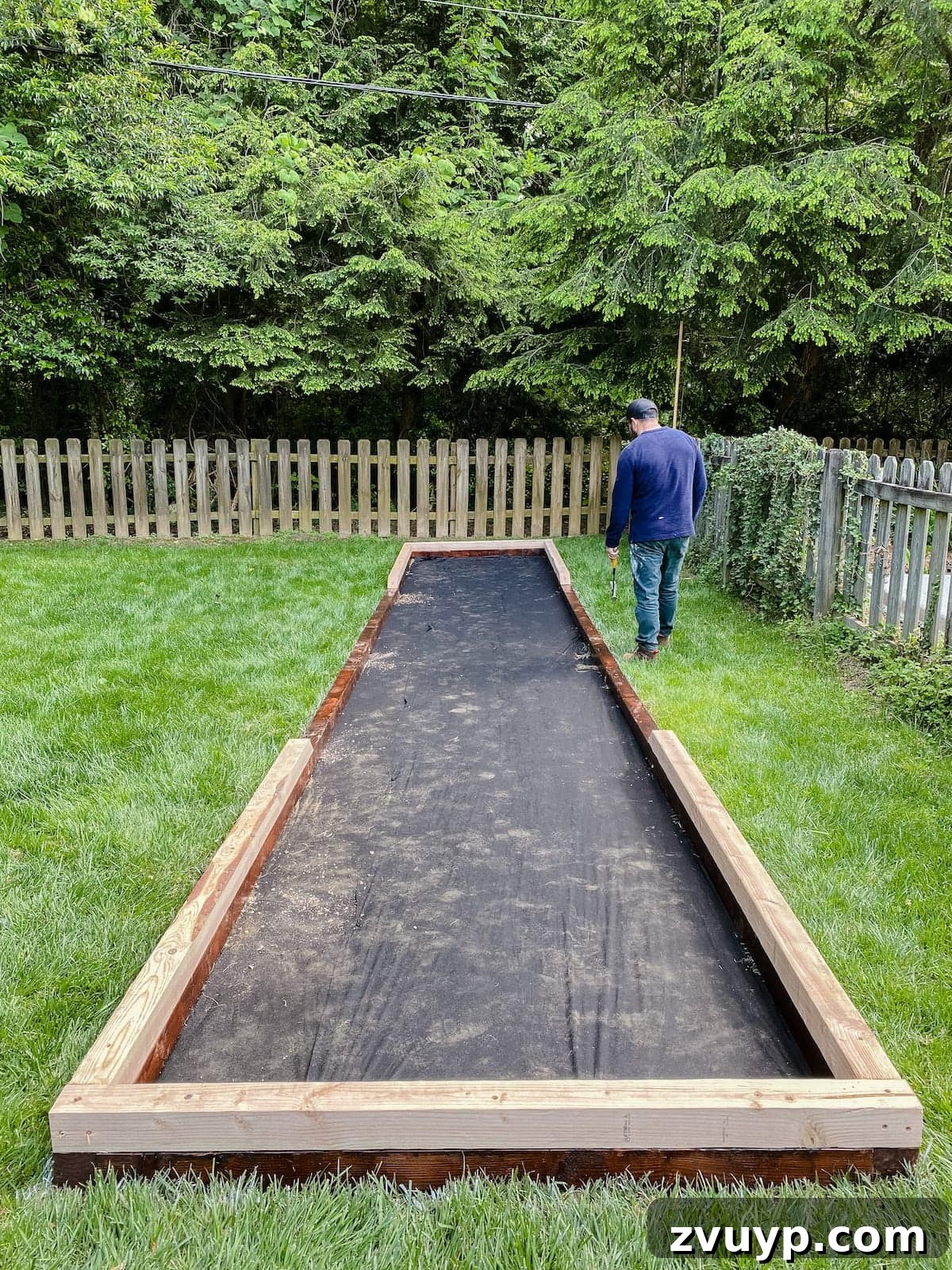 Get Rolling Build a Bocce Court in a Weekend 17 Bocce ball court frame with stacked boards and weed fabric base