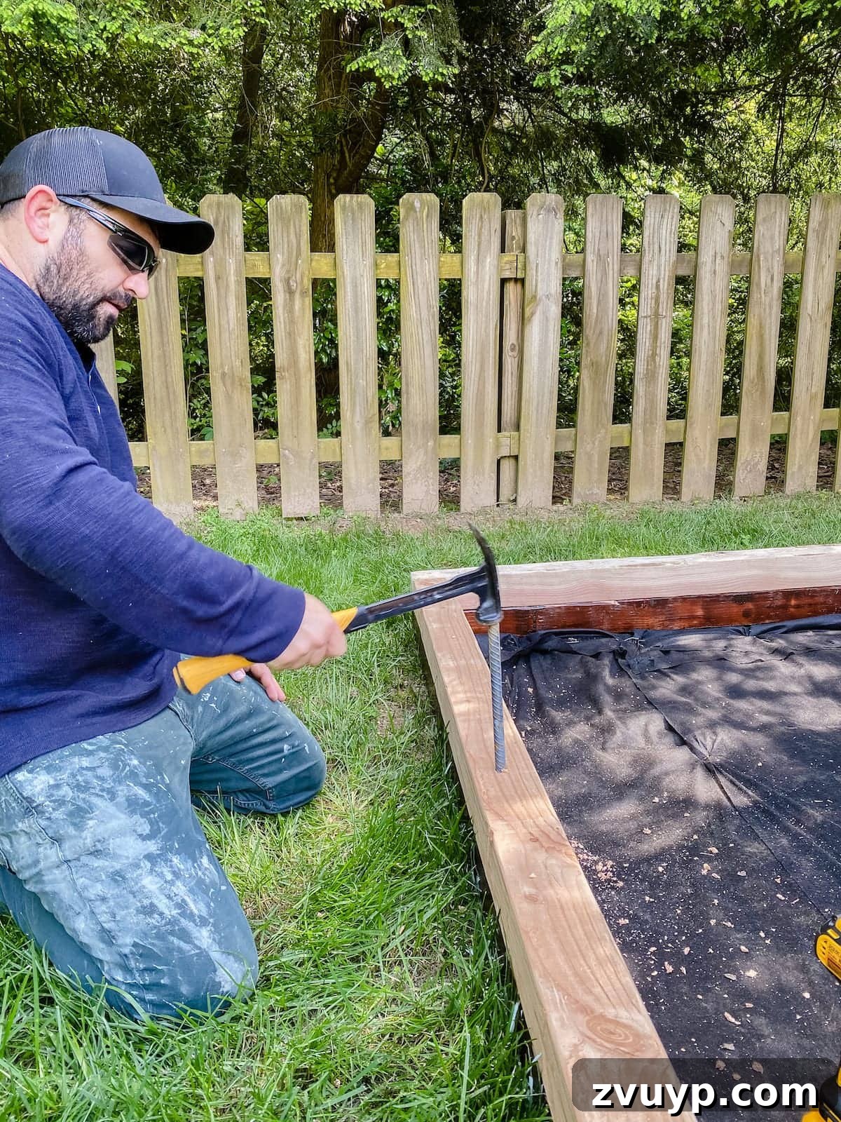 Get Rolling Build a Bocce Court in a Weekend 19 Driving rebar spikes into the bocce ball court frame for stability