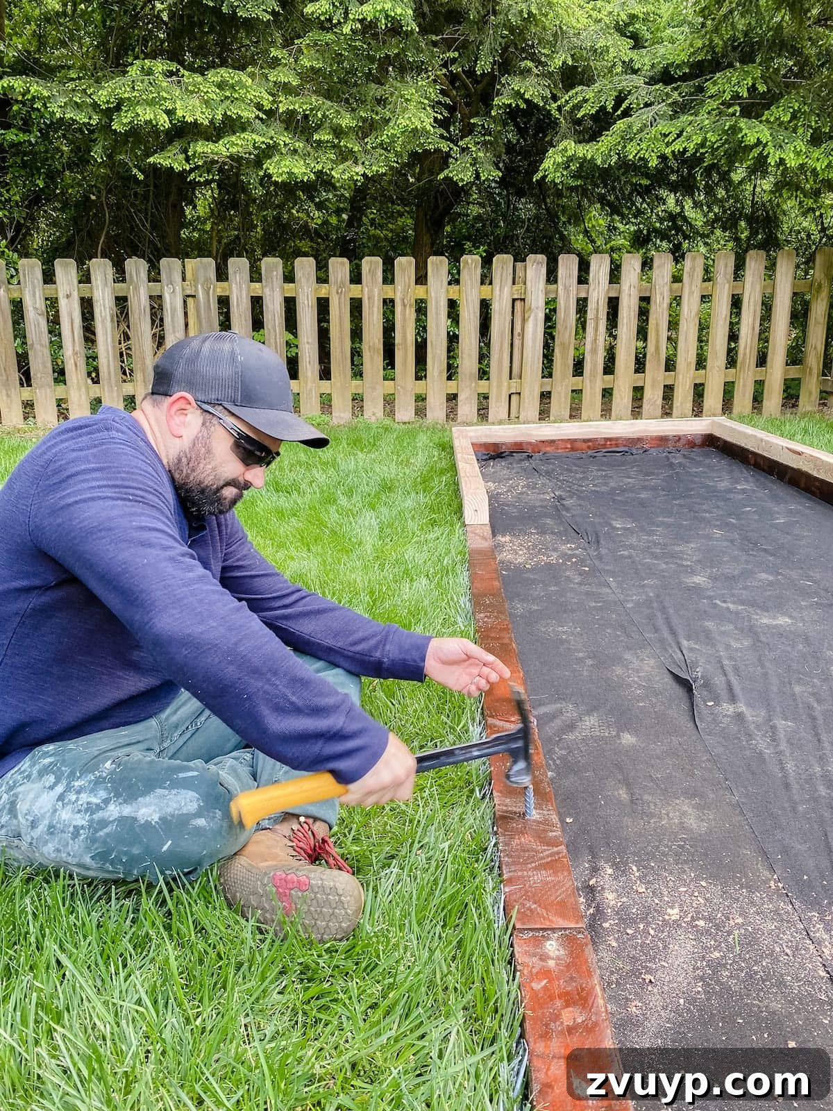 Get Rolling Build a Bocce Court in a Weekend 20 Anchoring the bocce ball court frame securely with multiple rebar spikes