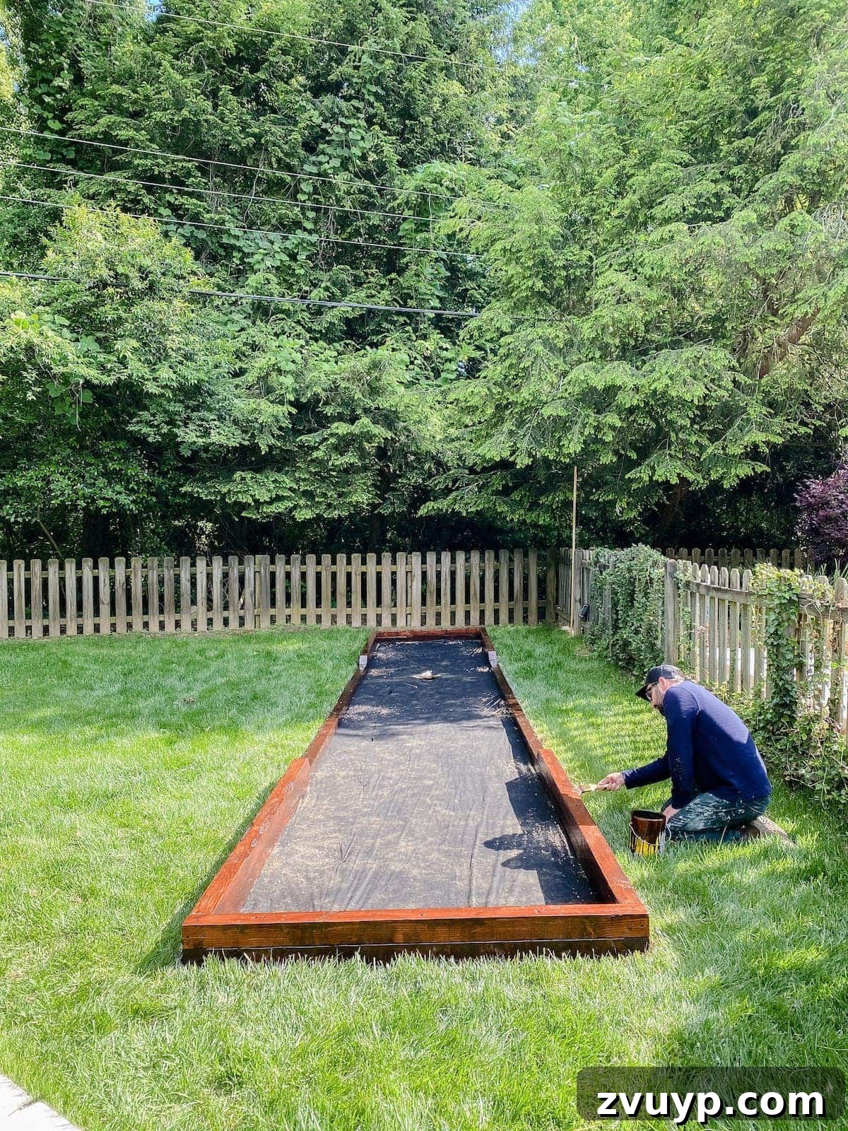 Get Rolling Build a Bocce Court in a Weekend 21 Touching up the bocce ball court frame with waterproofing stain