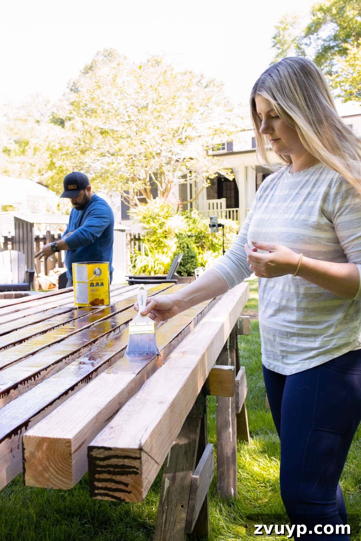 Get Rolling Build a Bocce Court in a Weekend 5 Applying waterproofing stain to 4x4 cedar wood boards for the bocce court frame