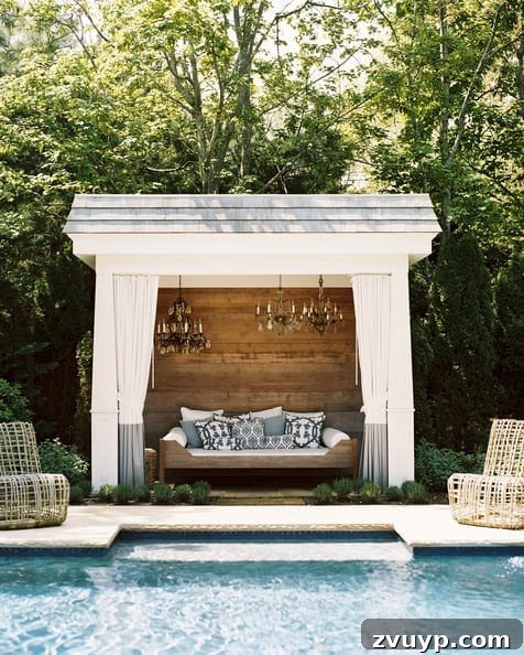 7 Pool Cabana Ideas for Your Backyard Oasis 7 Compact yet stylish white pool cabana featuring a rustic wood accent wall, designed for efficient use of space on a pool deck.
