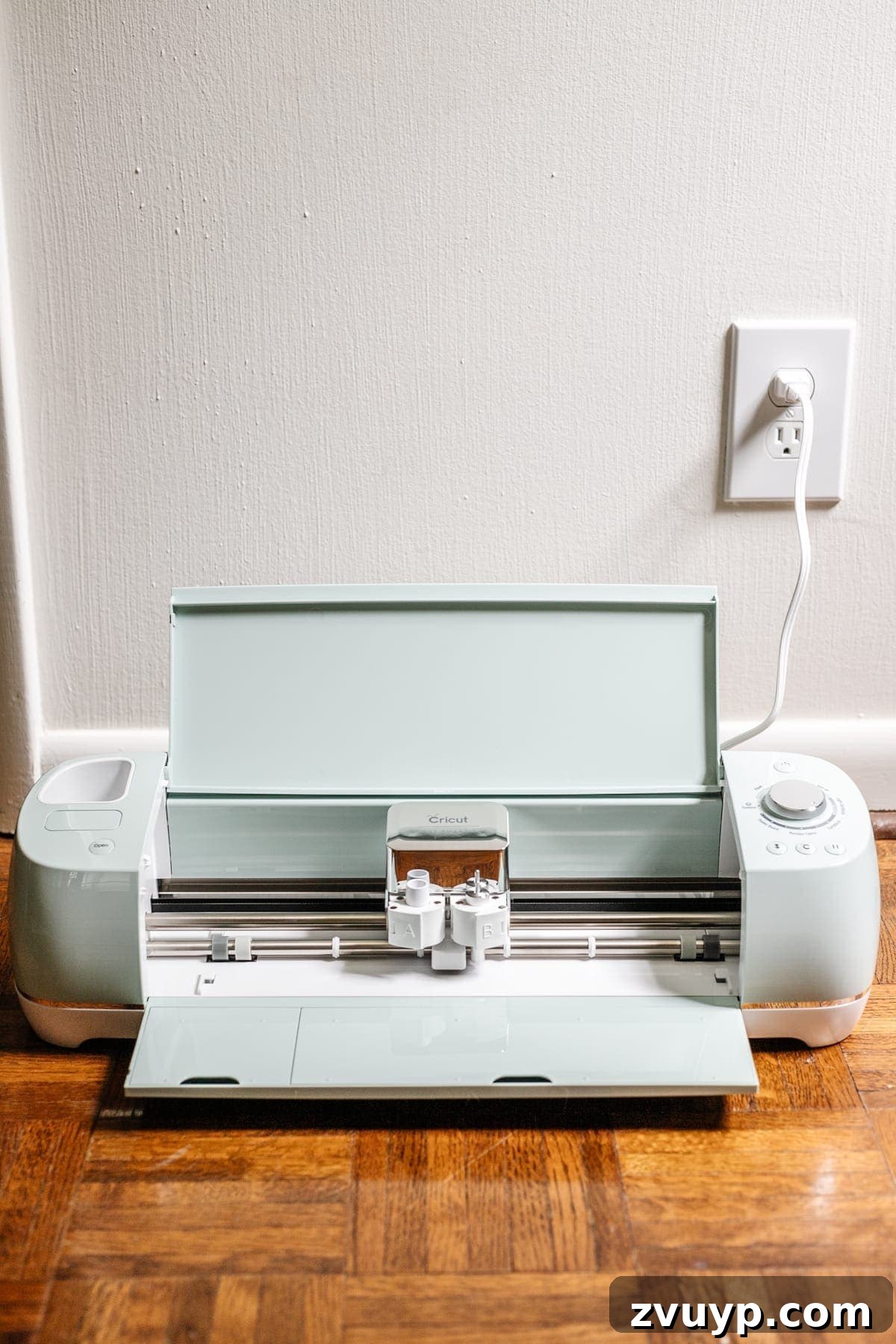 Craft a Custom Floral Outdoor Rug with a Cricut Stencil 12 Cricut machine actively cutting a custom stencil from an acetate sheet