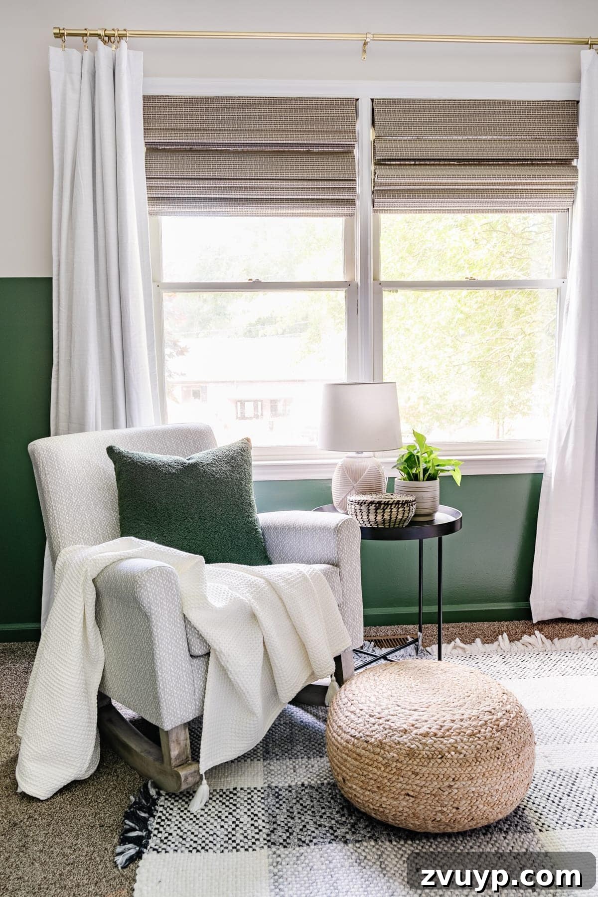 Little Explorer's Woodland Nursery Transformation 13 A beautifully appointed nursery with deep green walls, a cozy plaid rug, and a comfortable gray rocking chair.