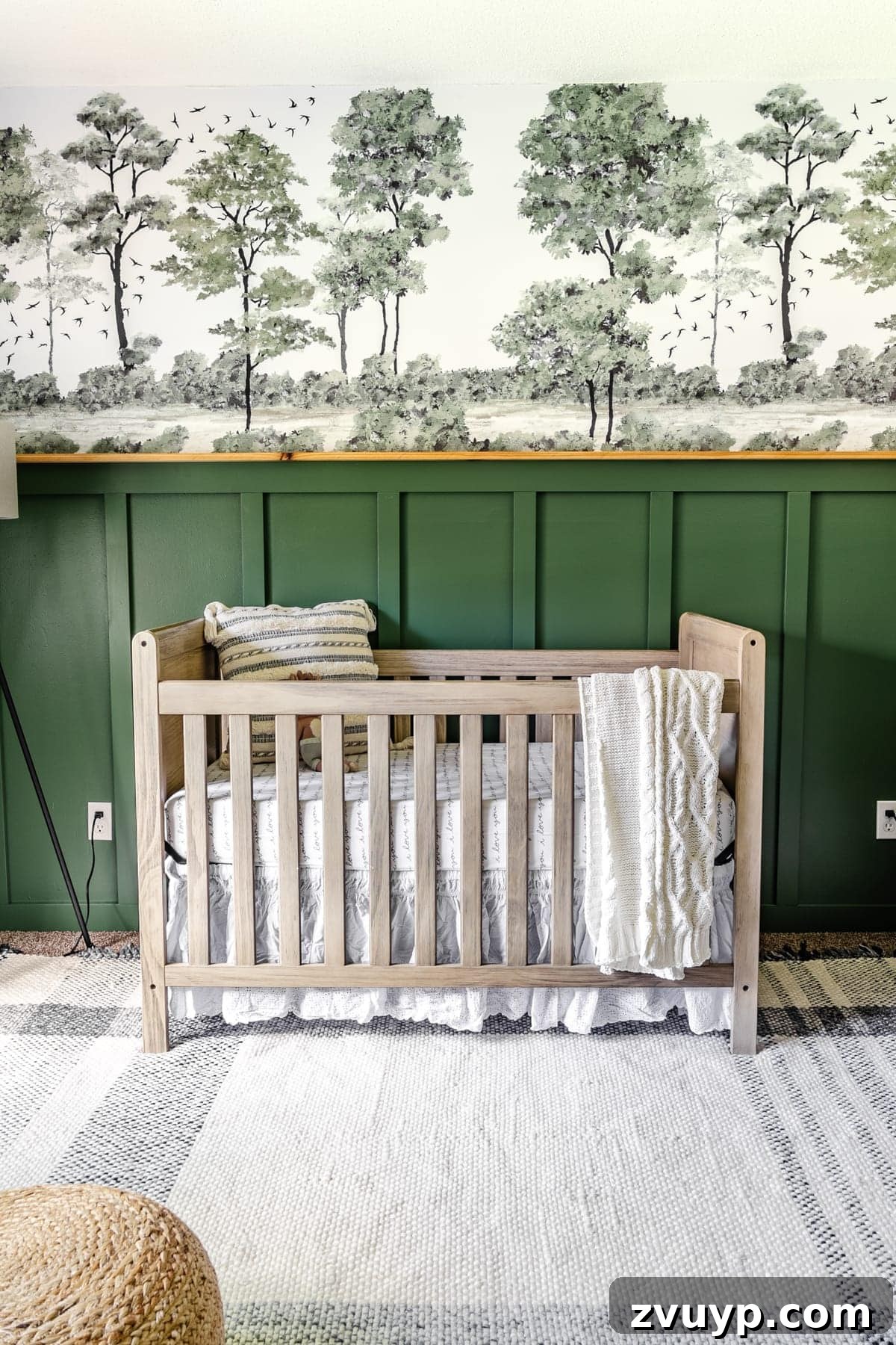 Little Explorer's Woodland Nursery Transformation 14 A charming baby boy nursery with a woodland theme, featuring deep green paint and an enchanting peel & stick tree mural.