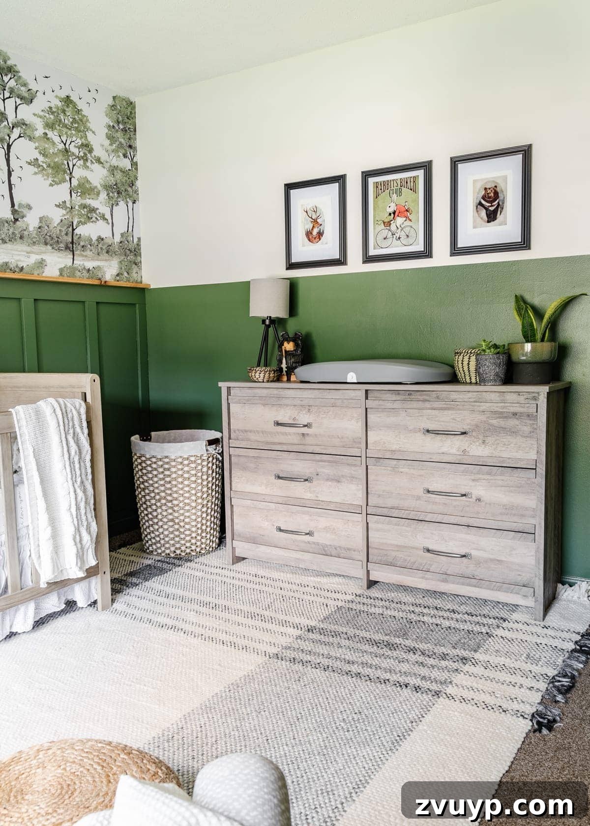 Little Explorer's Woodland Nursery Transformation 6 Woodland nursery idea showcasing a forest wall mural, weathered wood furniture, a plaid rug, and charming woodland animal art.