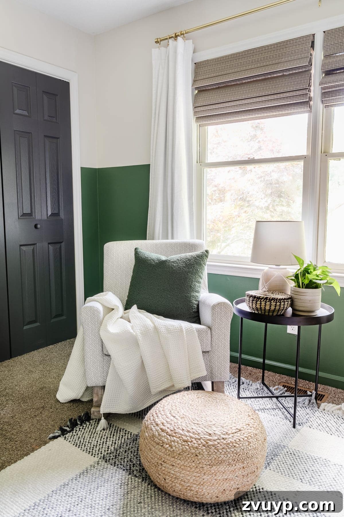 Little Explorer's Woodland Nursery Transformation 10 A serene nursery rocking chair with a gray pattern, complemented by a plaid rug, deep green walls, blackout curtains, and a practical side table.