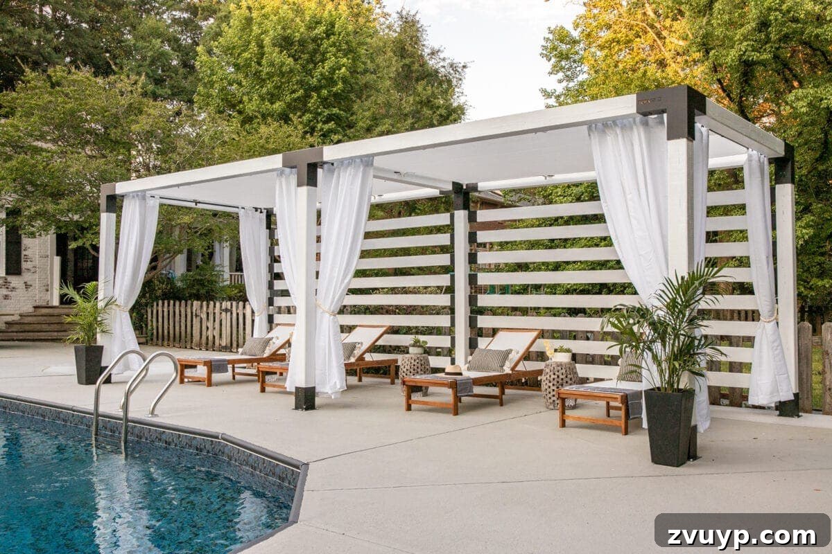 Build Your Own Backyard Oasis: A DIY Luxury Pool Cabana Pergola 15 white DIY pergola cabana with outdoor curtains and lounge chairs, highlighting the painted concrete