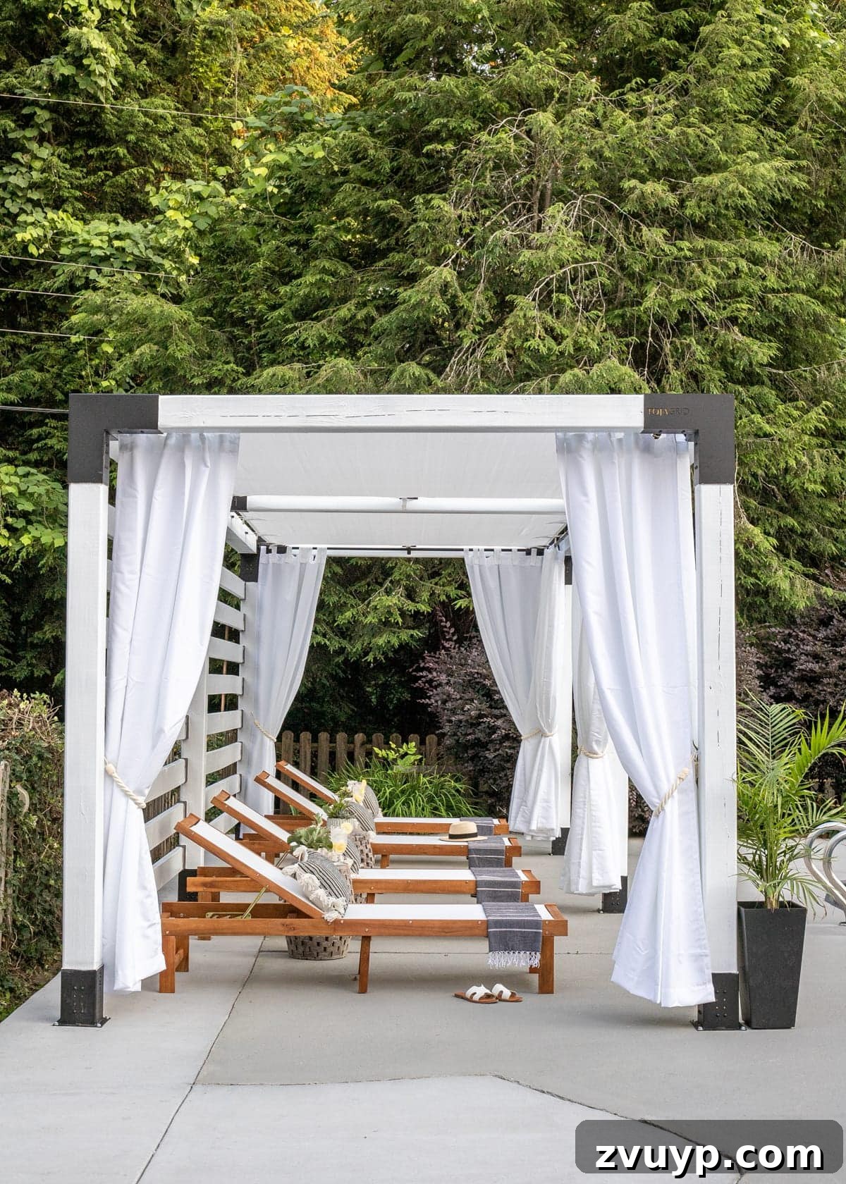 Build Your Own Backyard Oasis: A DIY Luxury Pool Cabana Pergola 5 white DIY pergola cabana with outdoor curtains and lounge chairs, showcasing its inviting atmosphere