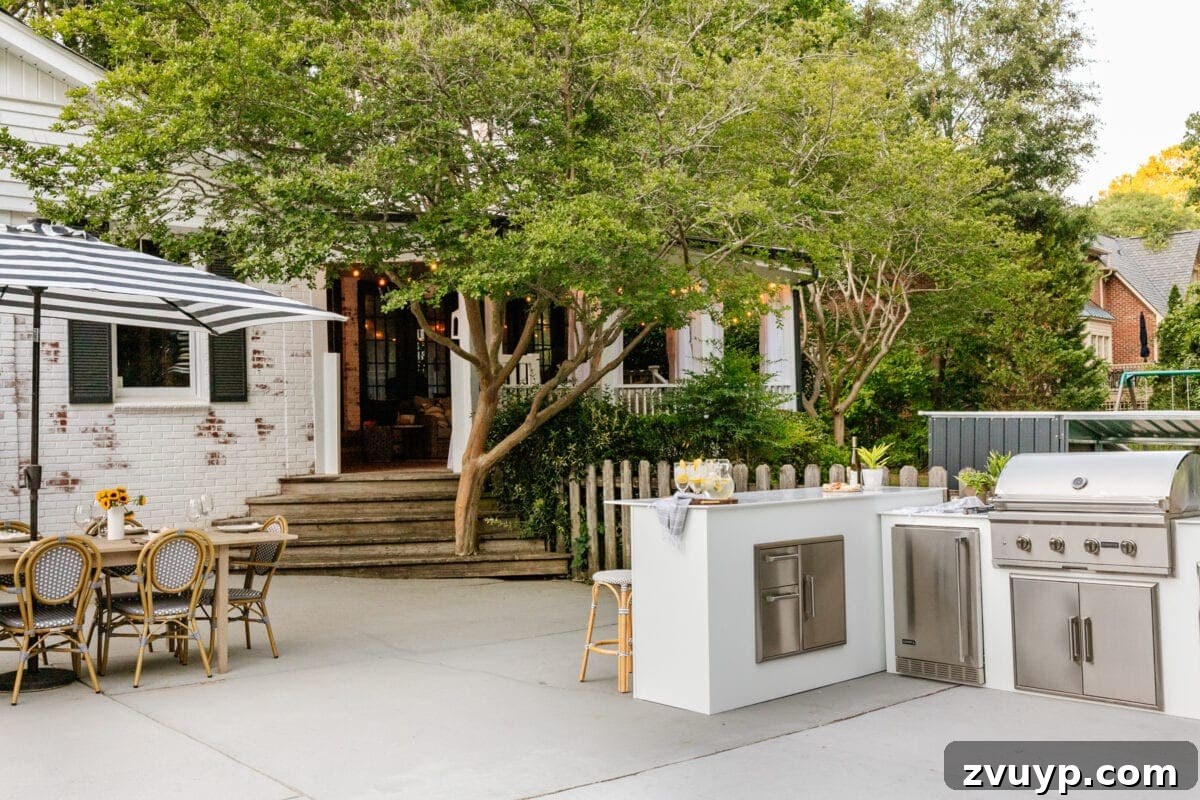 Effortless DIY Outdoor Kitchen Kit Build: Essential Tips 15 Elegant white modular outdoor kitchen from RTA Outdoor Living blending seamlessly with a limewashed brick house, showcasing its clean lines.