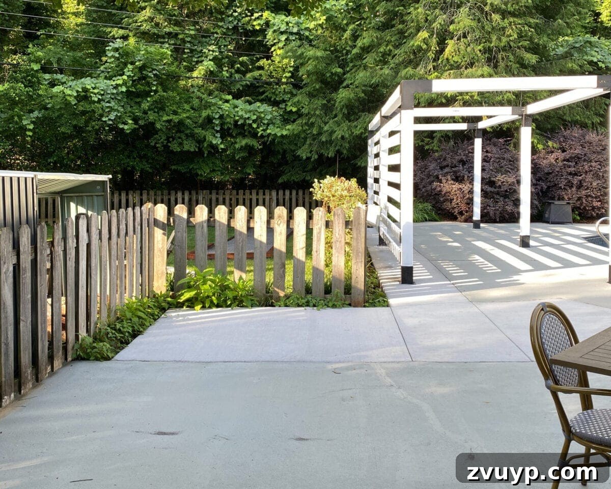 Effortless DIY Outdoor Kitchen Kit Build: Essential Tips 3 A plain concrete slab in a backyard corner, serving as the 'before' photo for an outdoor kitchen installation.