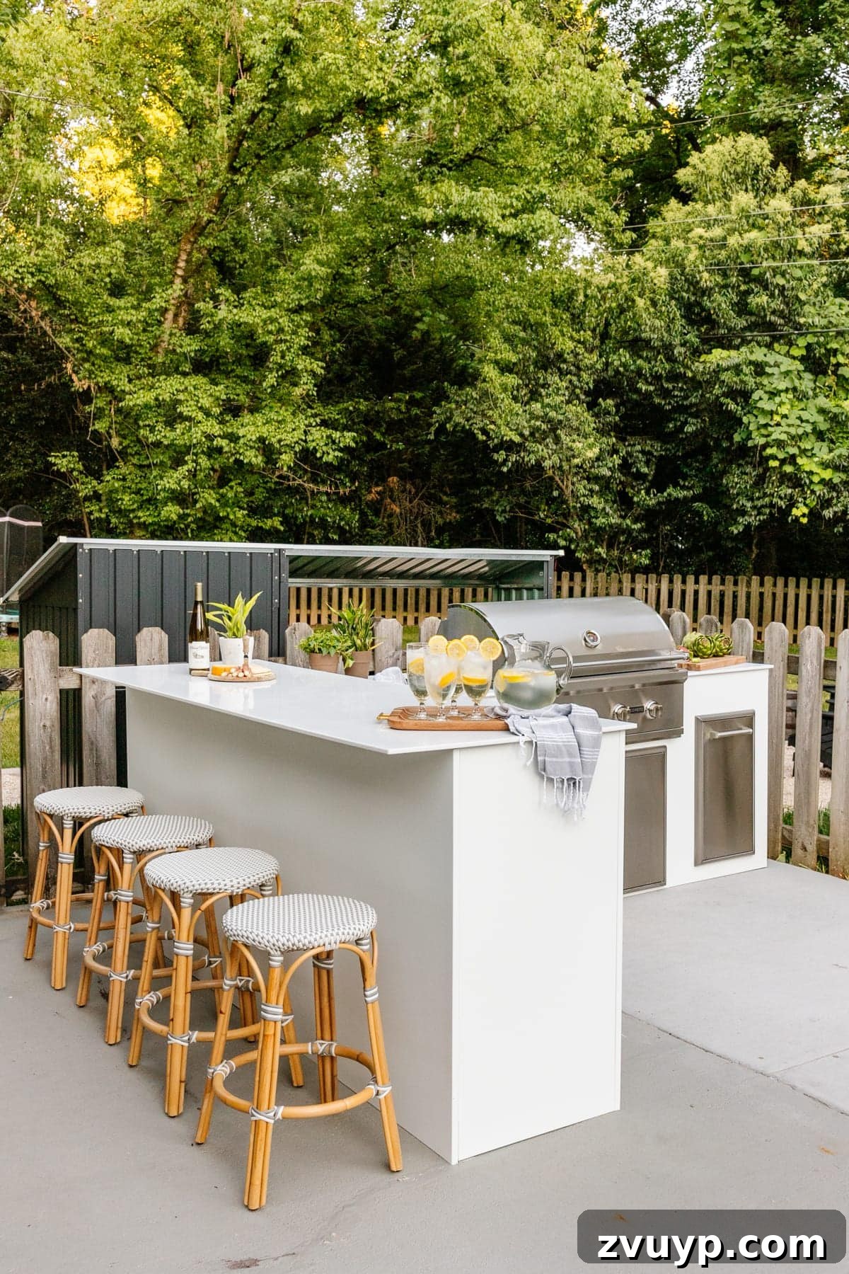 Effortless DIY Outdoor Kitchen Kit Build: Essential Tips 21 A couple enjoying their newly built white modular outdoor kitchen, showcasing the ease of assembly and satisfaction of the finished product.