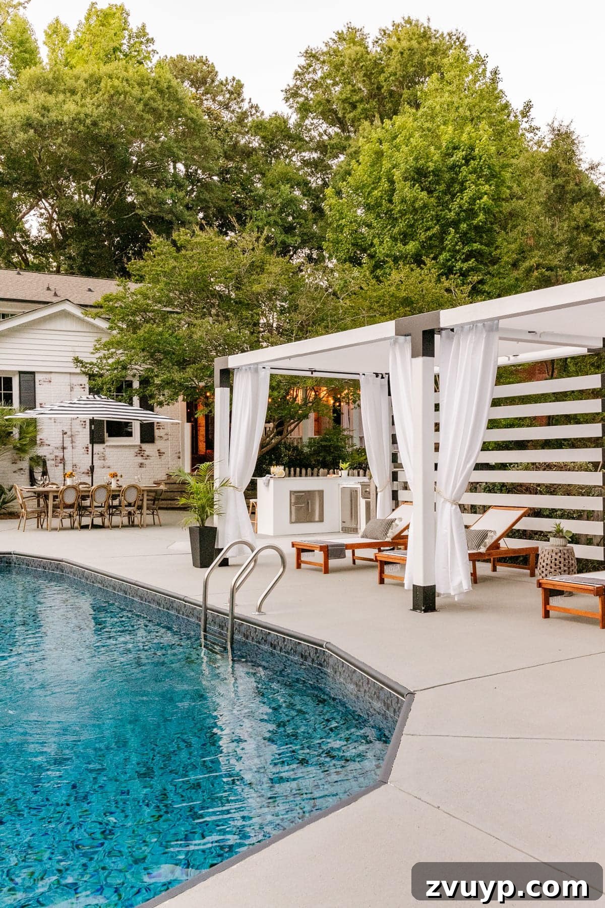Effortless DIY Outdoor Kitchen Kit Build: Essential Tips 24 An inviting backyard scene with a swimming pool, integrated modular outdoor kitchen, and a stylish pergola-covered dining area.