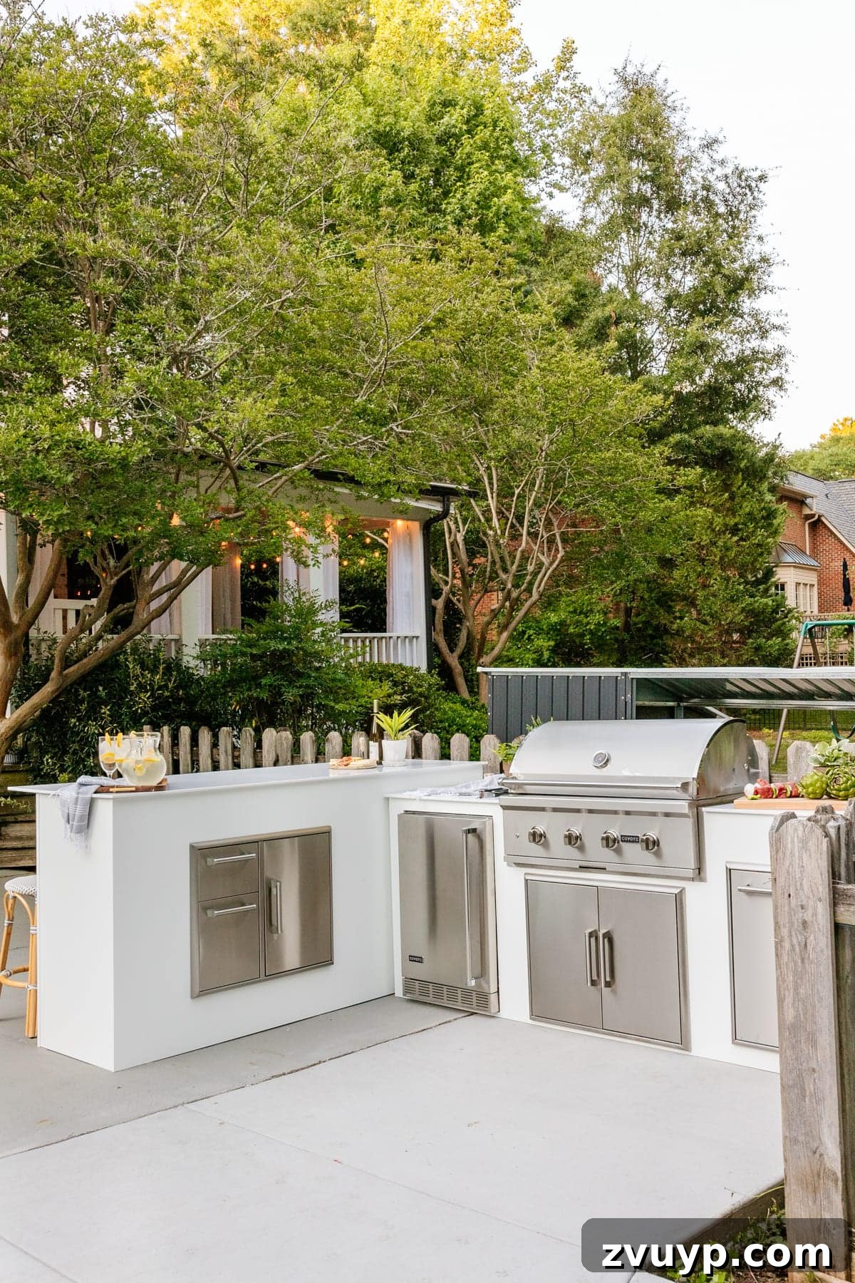 Effortless DIY Outdoor Kitchen Kit Build: Essential Tips 7 A beautifully designed modular outdoor kitchen with sleek white cabinets and integrated grill in a sunny backyard setting.